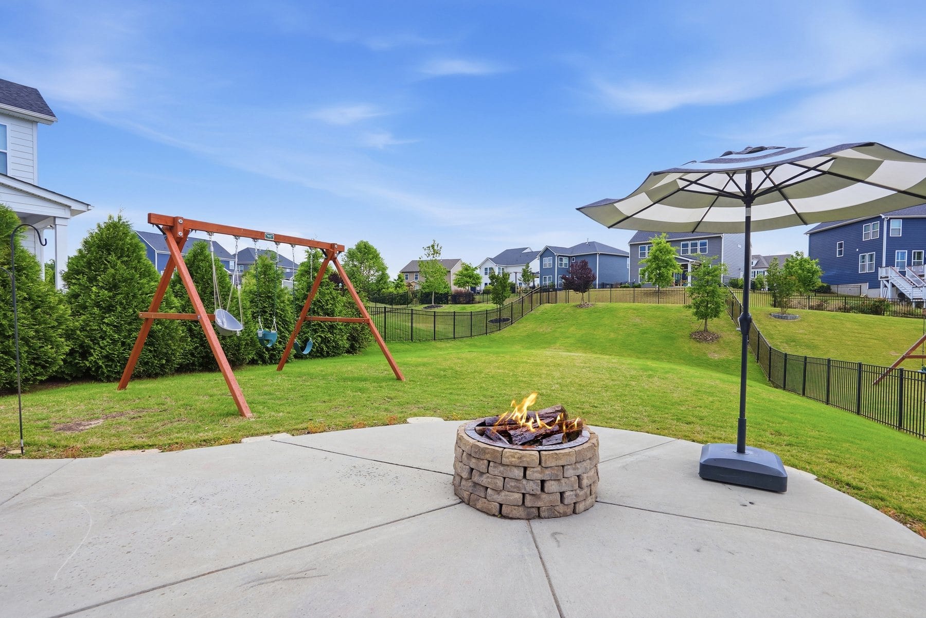 Rear elevation of the home with its covered patio and fenced yard